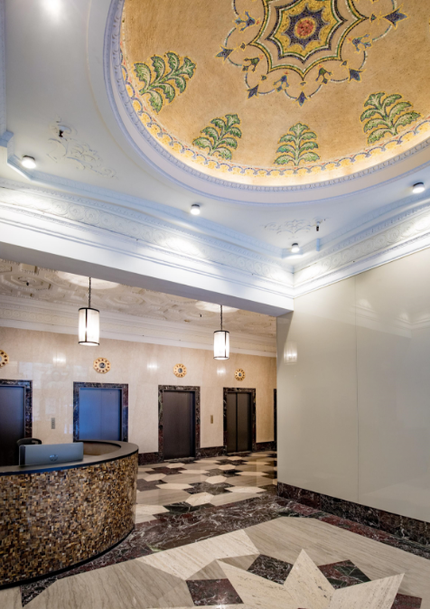 a room with a large ceiling and a large rug